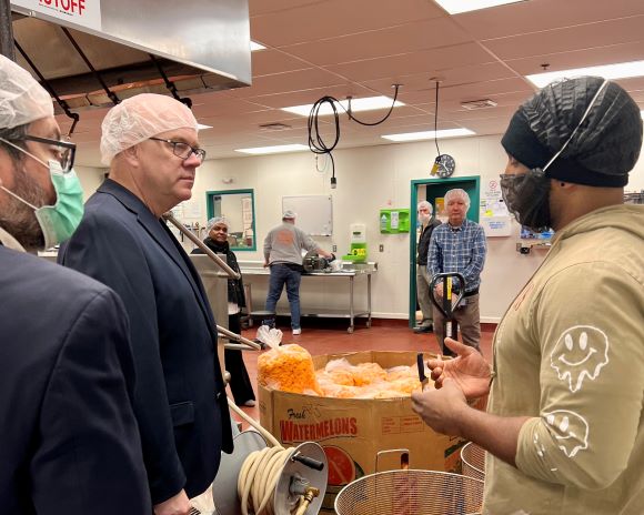 Jim at a food distribution center in a hair net